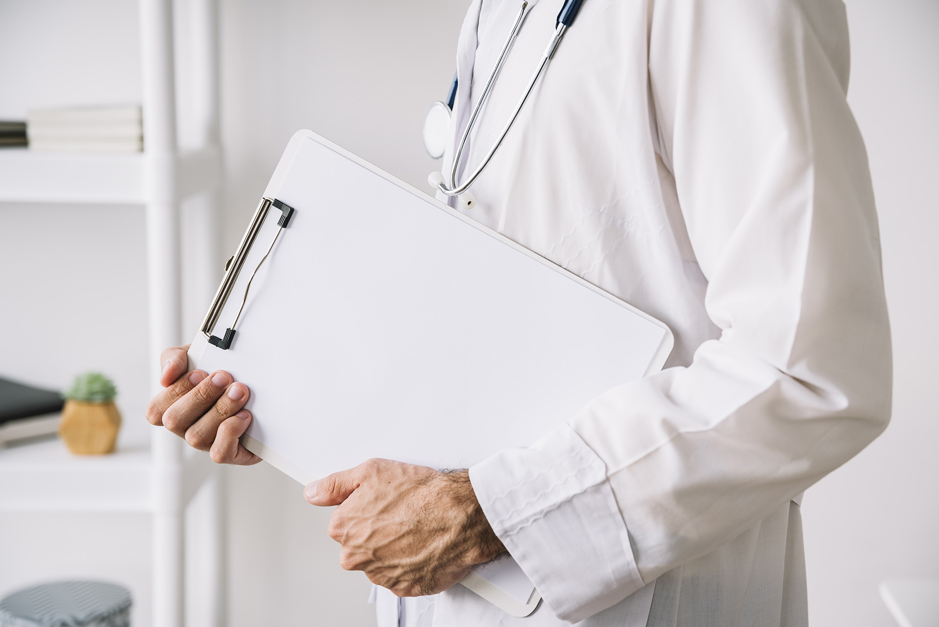 midsection-view-doctor-hand-holding-clipboard-with-blank-white-paper